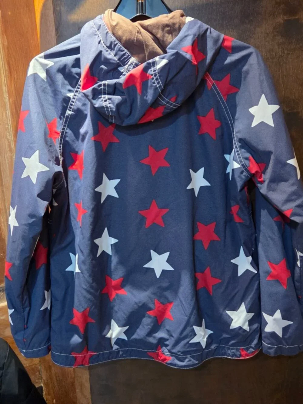 rain jacket features a navy blue background covered in a bold red and white star